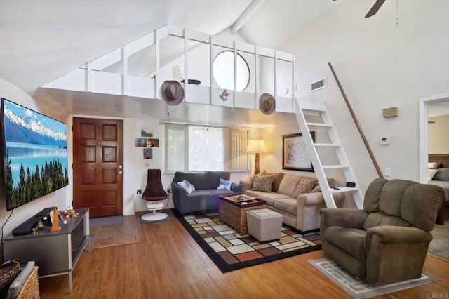 living room featuring beam ceiling, high vaulted ceiling, and wood-type flooring