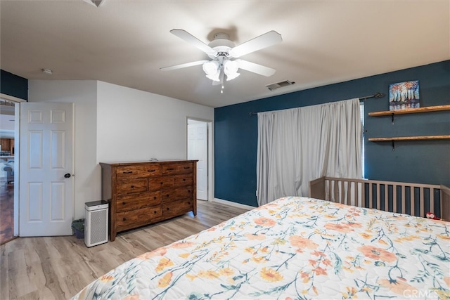 bedroom with light hardwood / wood-style floors and ceiling fan