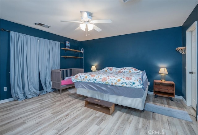 bedroom with light wood-type flooring and ceiling fan