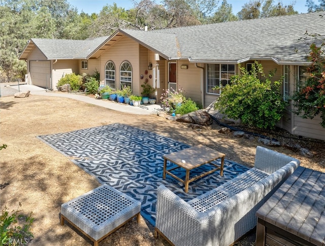 rear view of house with a garage