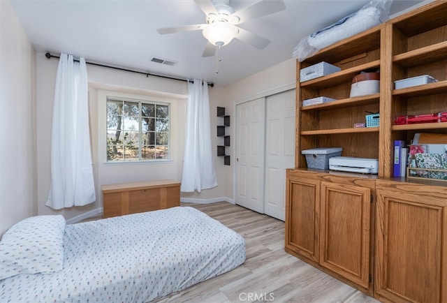 bedroom with a closet, ceiling fan, and light wood-type flooring