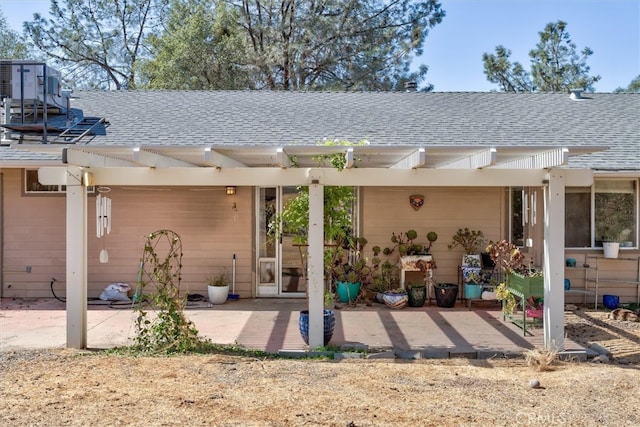 rear view of property with a patio and a pergola