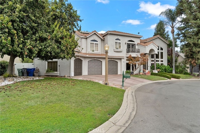 2550 E Jenny Ave, Fresno, CA 93720 - mediterranean / spanish house with a balcony, a front lawn, and a garage