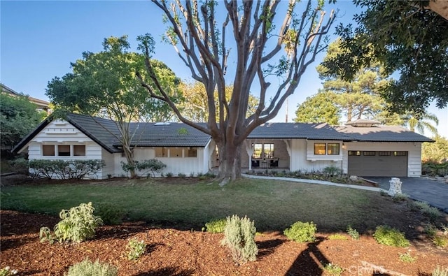 ranch-style house with a garage and a front lawn