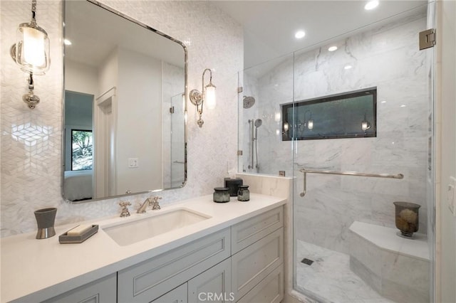 bathroom featuring vanity and a shower with door