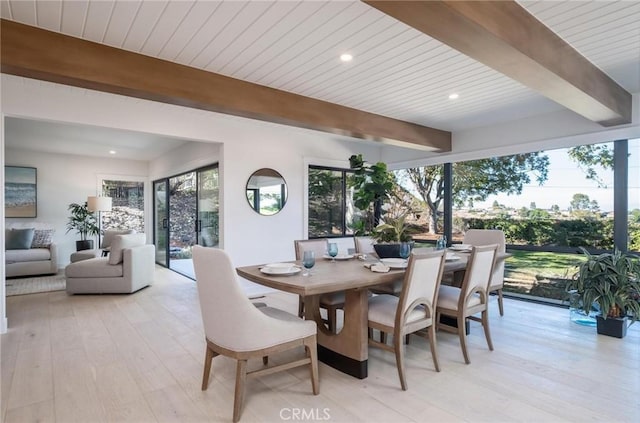 dining space featuring beam ceiling, light hardwood / wood-style floors, and wood ceiling