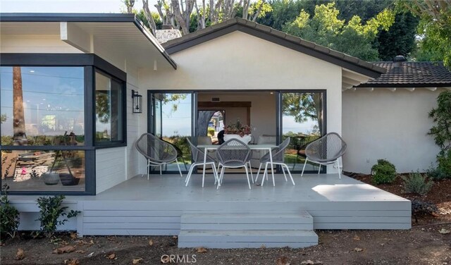 back of property with a wooden deck