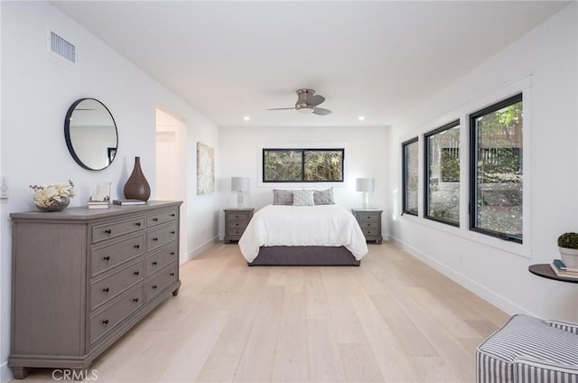 bedroom featuring multiple windows, ceiling fan, and light hardwood / wood-style flooring