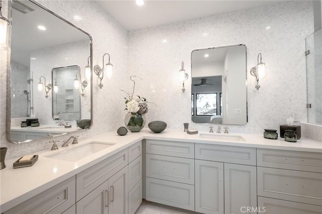 bathroom featuring ceiling fan, a shower with door, and vanity