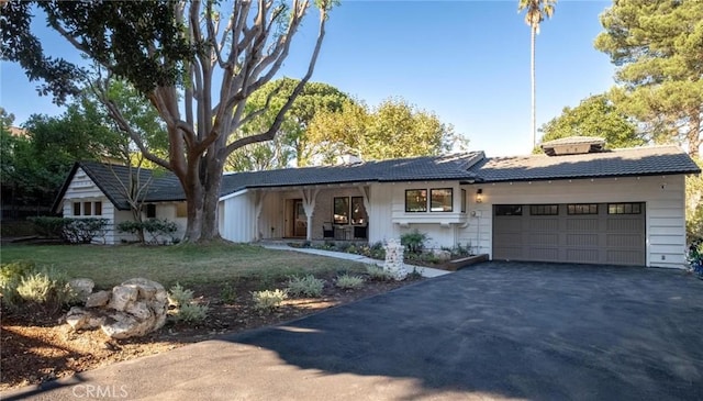 ranch-style home featuring a front yard and a garage