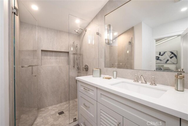 bathroom featuring vanity and a shower with shower door