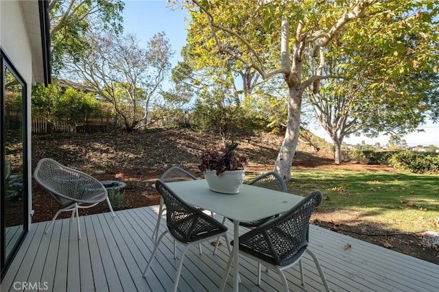 wooden terrace featuring a yard