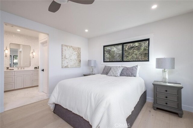 bedroom featuring multiple windows, light wood-type flooring, ensuite bath, and ceiling fan