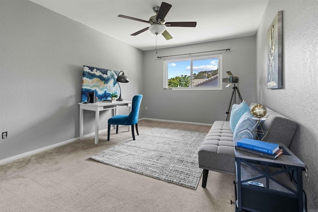 carpeted office space featuring ceiling fan