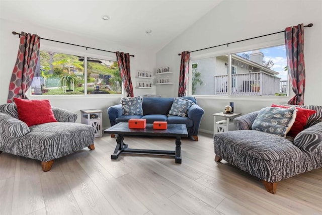 living room with light hardwood / wood-style floors and lofted ceiling