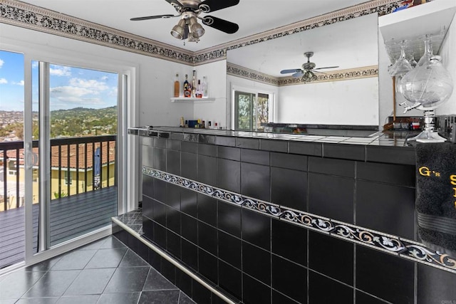 interior space featuring tile patterned floors and ceiling fan