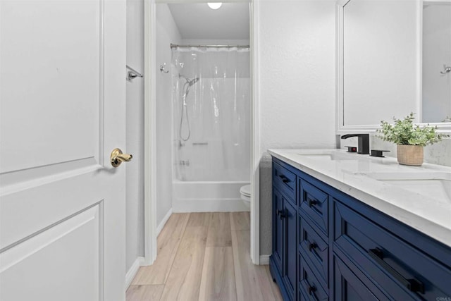 full bathroom with vanity, toilet, wood-type flooring, and shower / bath combo with shower curtain