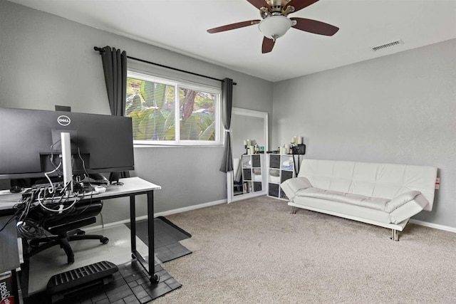 carpeted office space featuring ceiling fan