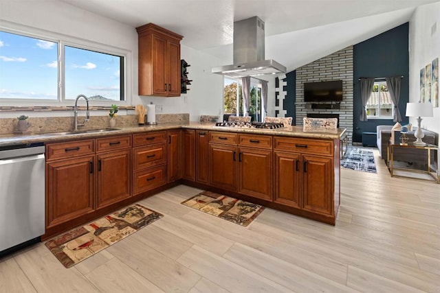 kitchen with sink, vaulted ceiling, island range hood, appliances with stainless steel finishes, and light wood-type flooring