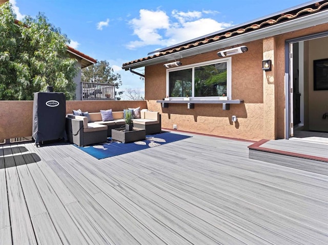 wooden deck with an outdoor living space