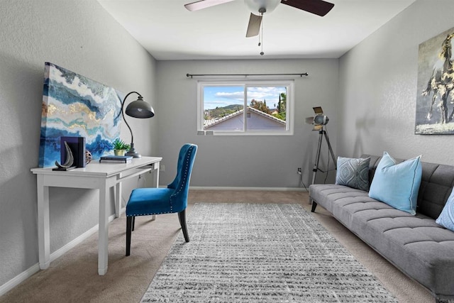 home office featuring ceiling fan and light carpet