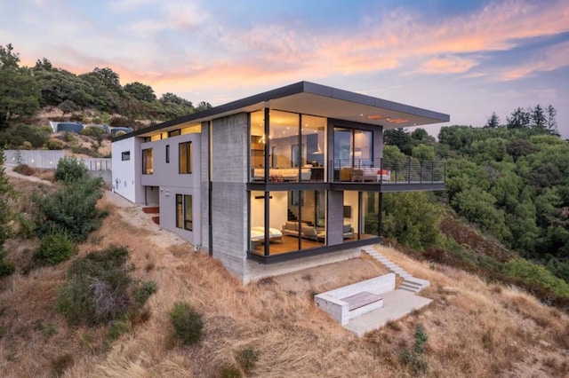 view of back house at dusk