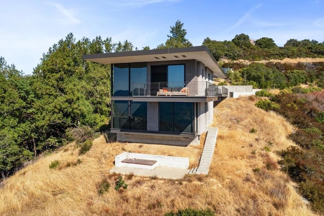 rear view of house featuring a balcony