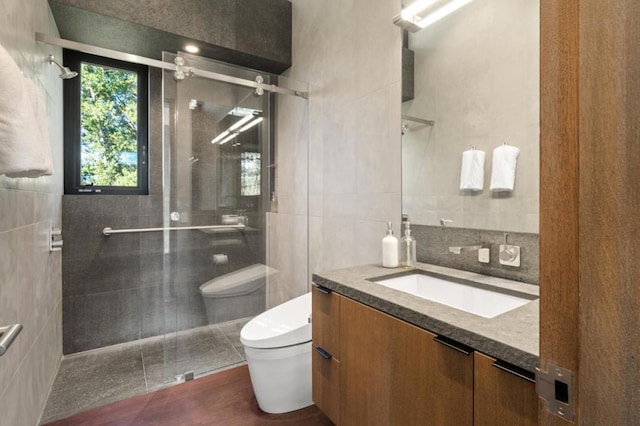 bathroom featuring toilet, an enclosed shower, tile patterned floors, and vanity