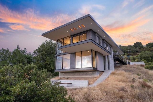 view of back house at dusk