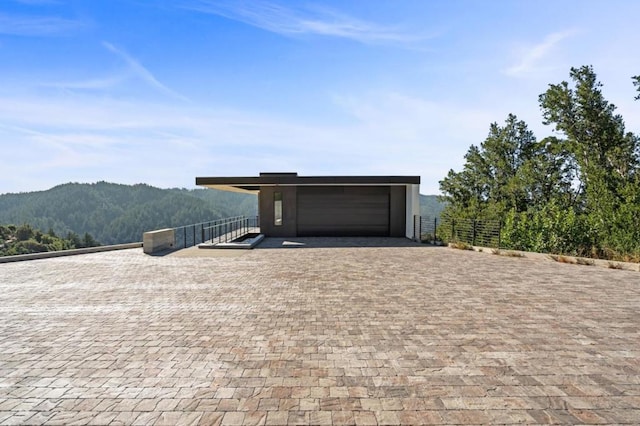 view of front facade with a garage and a mountain view