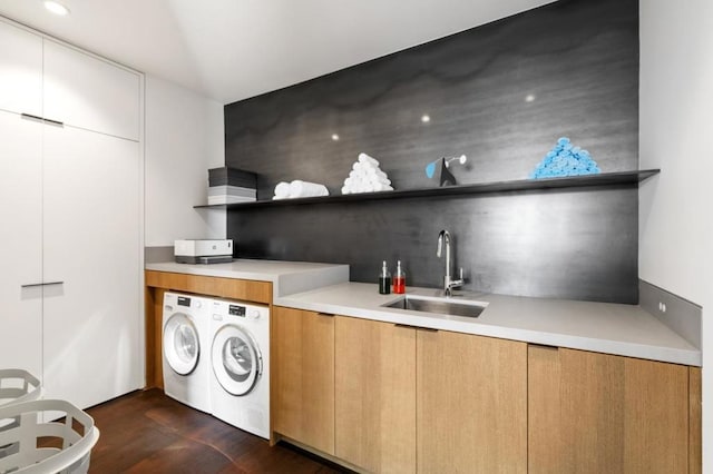 kitchen featuring sink, white cabinetry, and independent washer and dryer