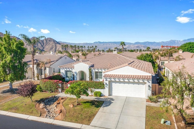 mediterranean / spanish home featuring a garage and a mountain view