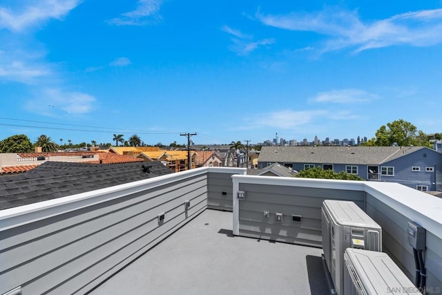 view of patio with ac unit and a balcony