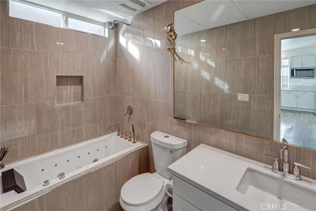 full bathroom featuring vanity, tiled shower / bath combo, and tile walls