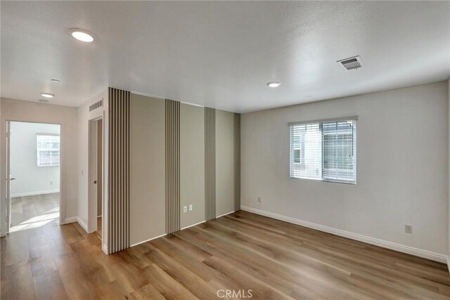 spare room with light hardwood / wood-style floors