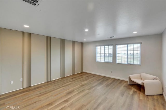 unfurnished room with light hardwood / wood-style floors