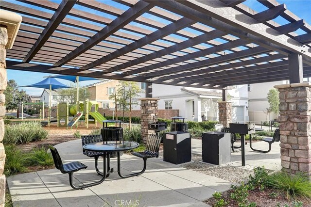 view of patio / terrace featuring a pergola and a playground