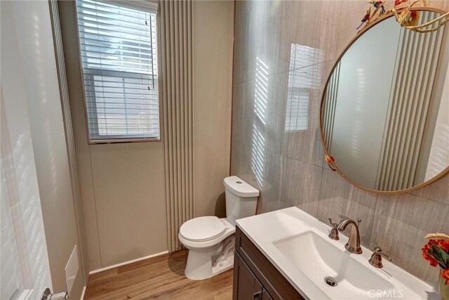 bathroom featuring vanity, hardwood / wood-style flooring, and toilet