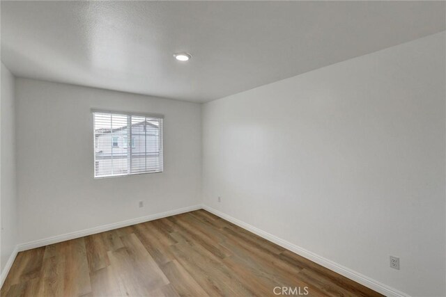 spare room with light hardwood / wood-style flooring