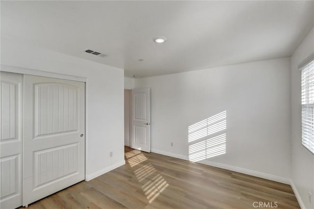 unfurnished bedroom featuring a closet and light hardwood / wood-style flooring