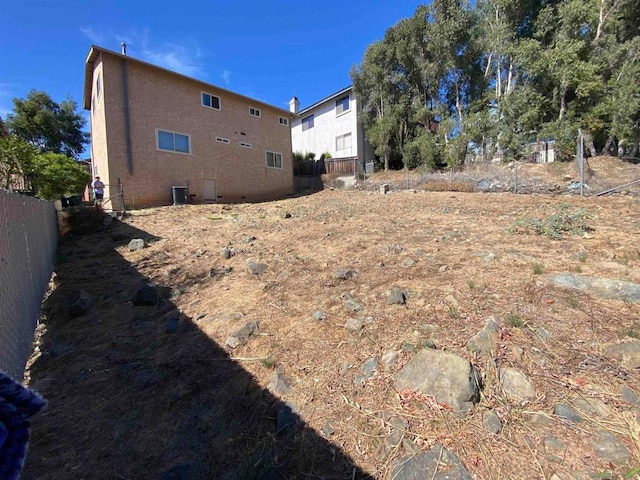 rear view of house with central AC unit