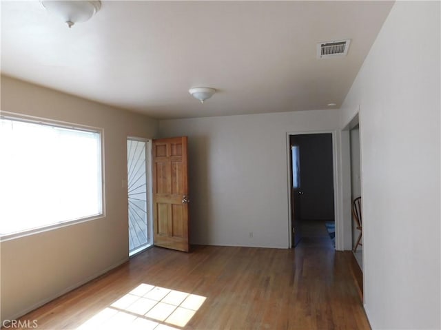 spare room featuring wood-type flooring