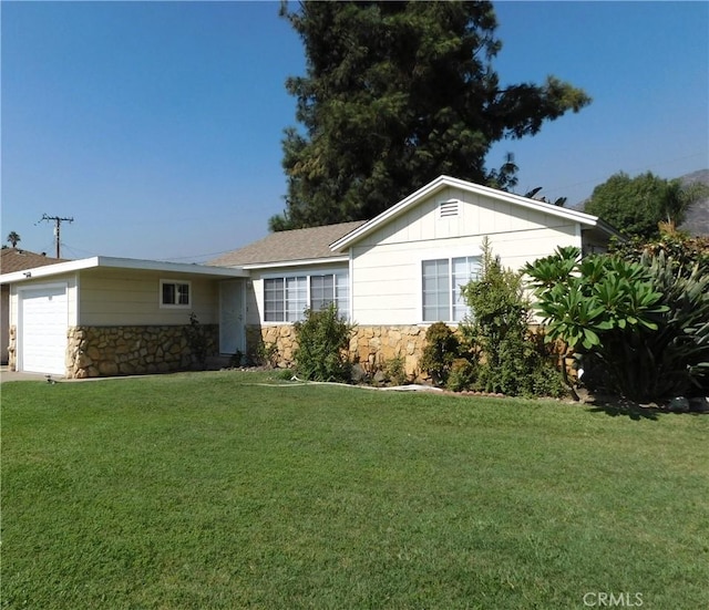 ranch-style home with a front yard and a garage