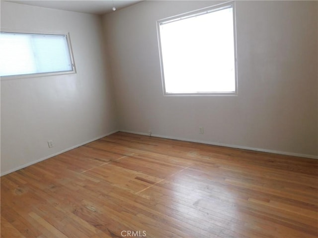 empty room with light hardwood / wood-style flooring