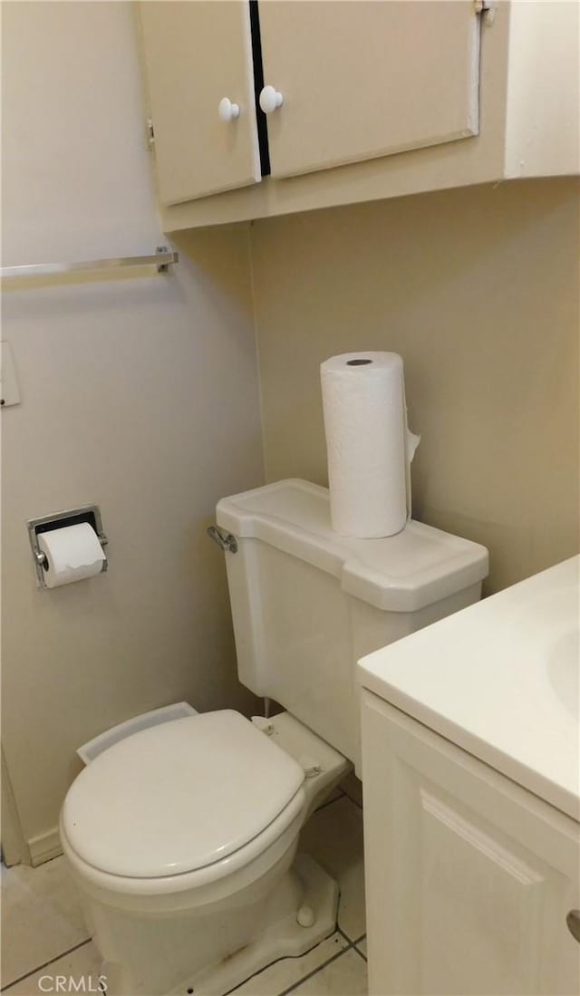 bathroom with tile patterned floors, vanity, and toilet