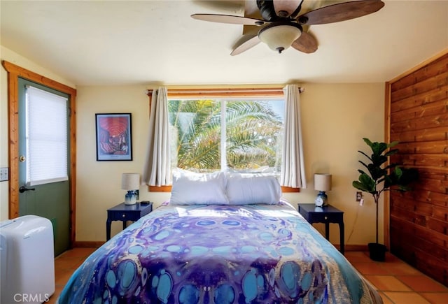 tiled bedroom featuring ceiling fan