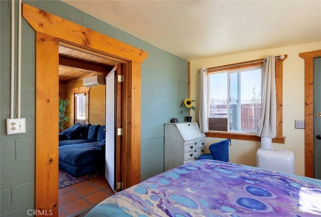 tiled bedroom featuring a wall unit AC