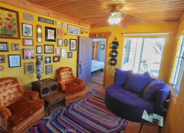 sitting room featuring wood ceiling and ceiling fan