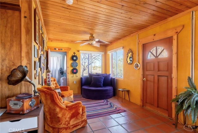 interior space featuring wood ceiling, light tile patterned floors, and ceiling fan