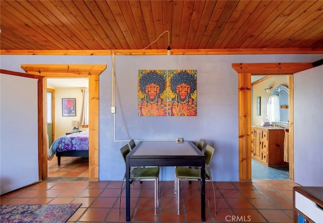 tiled dining area featuring wood ceiling